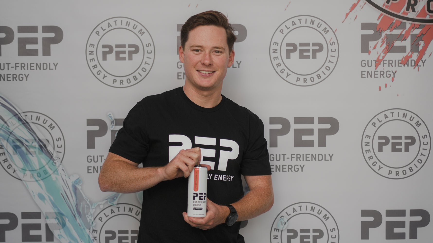 Conner Beasley holding a can of 'PEP' against a PEP-branded background